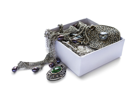 A lot of jewels in white opened box isolated over whiteの写真素材