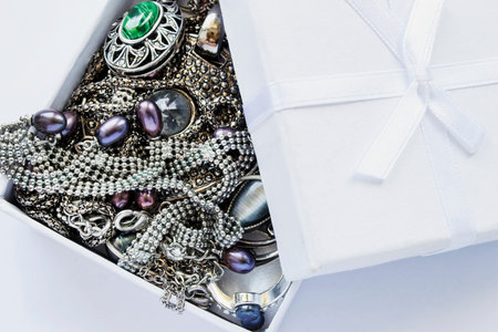 A lot of jewels in white opened box closeup as a background