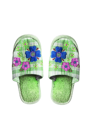 Pair of green textile home slippers on white backgroundの写真素材