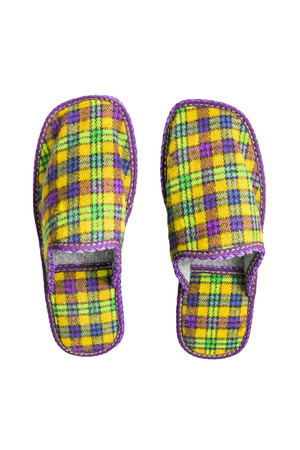 Pair of yellow squared slippers isolated over whiteの写真素材