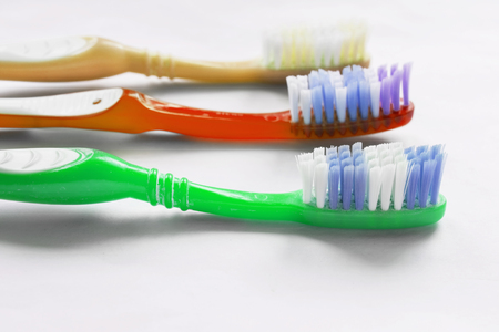 Group of three multicolor toothbrushes closeupの写真素材
