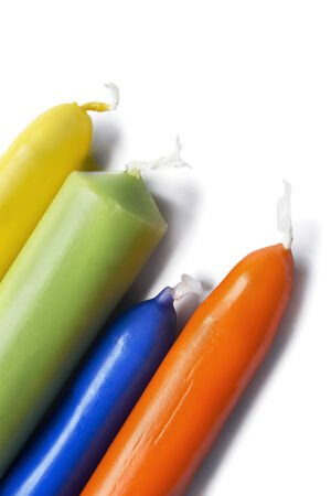 Four colorful long candles on white backgroundの写真素材