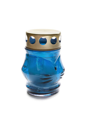 Blue glass lamp with candle inside on white backgroundの写真素材