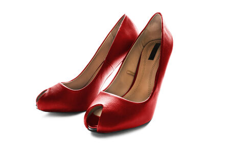 Pair of bright red leather high heeled shoes isolated over whiteの写真素材