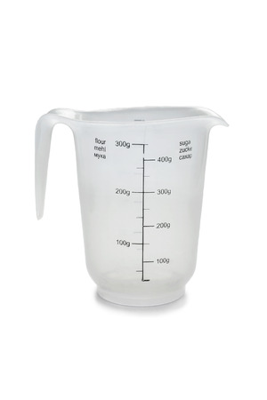 Empty measuring cup for flour and sugar isolated over whiteの写真素材
