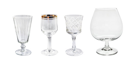 Set of four empty different wineglasses isolated over whiteの写真素材
