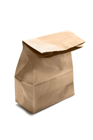 Closed blank kraft paper bag isolated over whiteの写真素材