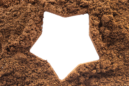 White silhouette of a star over coffee powder as a backgroundの写真素材