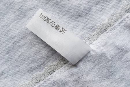 Gray cotton cloth with washing instructions label as a backgroundの写真素材