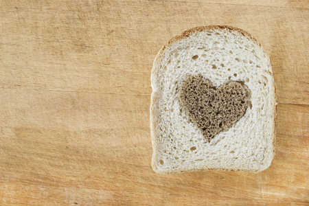 Piece of white bread on wooden board as a backgroundの写真素材