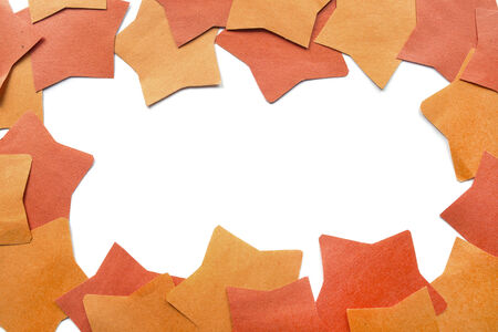 Blank frame of red and orange paper stars as a backgroundの写真素材