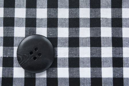 Black and white squared cloth with black big buttonの写真素材