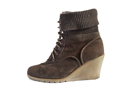 Brown shammy wedge heeled boot isolated over whiteの写真素材