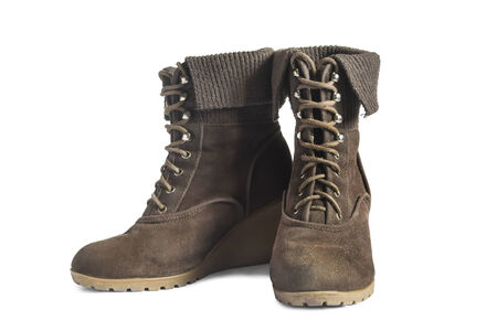 Pair of brown suede wedge boots with lacing isolated over whiteの写真素材