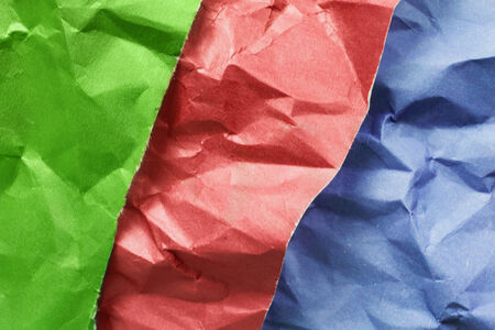 Group of three multicolor crumpled sheets of paper as a backgroundの写真素材