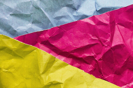 Three sheets of crumpled multicolor paper as a backgroundの写真素材