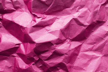 Crumpled pink paper closeup の写真素材