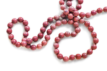 String of coral beads on white backgroundの写真素材