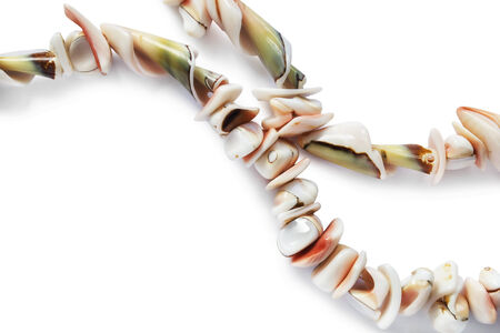 Strings of pink seashell beads on white backgroundの写真素材