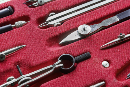 Set of drawing tools on red material closeup as a backgroundの写真素材
