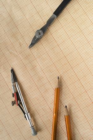 Drawing tools and pencils on blank graph paper as a backgroundの写真素材