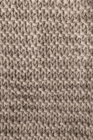 Texture of beige knitted cloth as a backgroundの写真素材