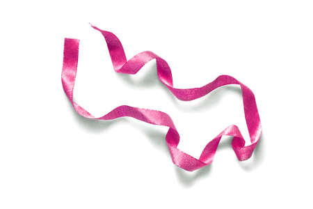 Pink textile shining ribbon isolated over whiteの写真素材
