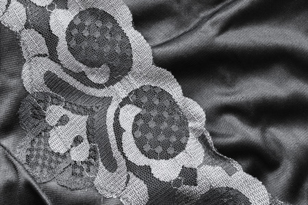 Black satin and lace closeup as a backgroundの写真素材