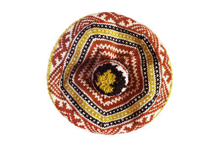Knitted colorful ornamental beret isolated over whiteの写真素材