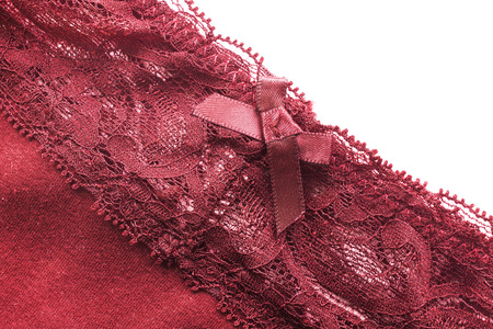 Red cloth with lacy border over white as a backgroundの写真素材