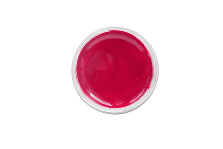 Red paint in a jar isolated over whiteの写真素材