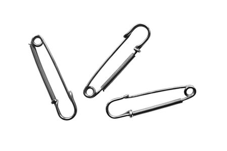 Group of three safety pins on white background