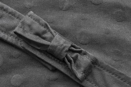Black textile bow on black cloth as a backgroundの写真素材