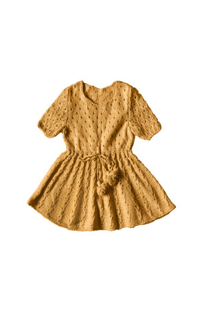 Yellow knitted baby dress on white backgroundの写真素材