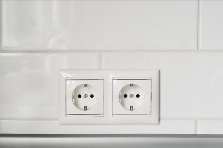 Double white socket on white wall as a backgroundの写真素材