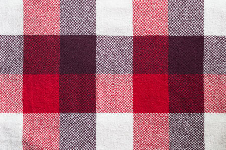 Red plaid wool material texture closeup as a backgroundの写真素材