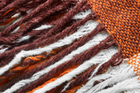 Wool brown and white fringe closeup as a backgroundの写真素材