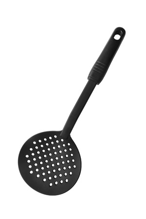 Black plastic slotted spoon on white backgroundの写真素材