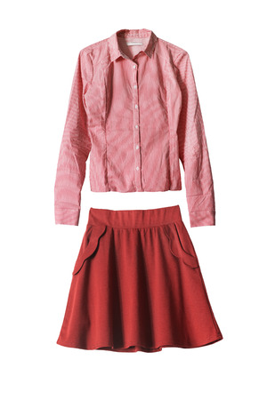 Set of red flared skirt and pink blouse on white backgroundの写真素材