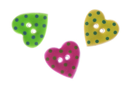 Bright buttons in the shape of a hearts isolated over whiteの写真素材