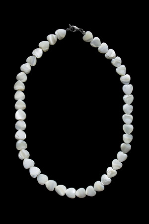 Heart shaped peal necklace isolated over blackの写真素材