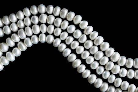 Strings of pearl on black as a backgroundの写真素材