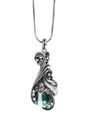 Vintage silver pendant with blue gemstone and crystals isolated over whiteの写真素材