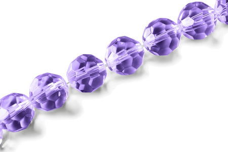String of purple crystal beads on white backgroundの写真素材