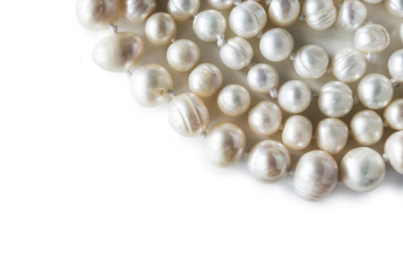 Strings of white pearl on white background