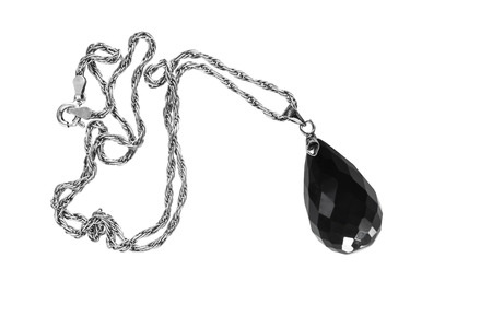 Black onyx pendant on white backgroundの写真素材