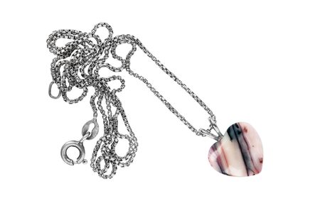 Agate pendant in the shape of a heart on white backgroundの写真素材