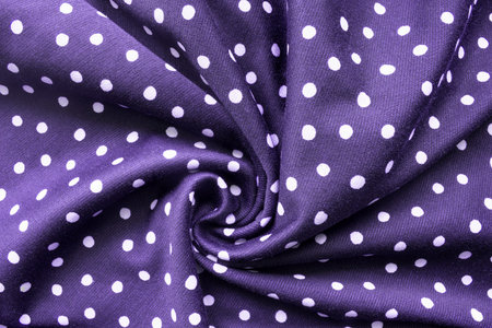Purple cloth with polka dots draped as a backgroundの写真素材