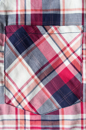 Pocket of plaid shirt closeup as a background