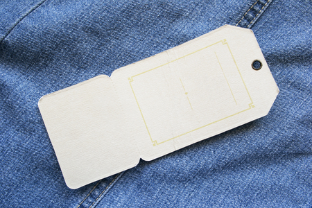 Blank label on blue denim as a backgroundの写真素材